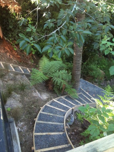 built in steps open the gully up, giving access to the rest of the garden